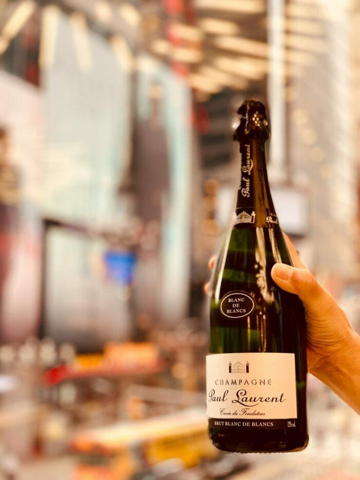 Hand holding a bottle of Champagne Paul Laurent